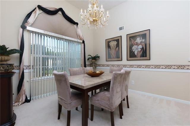 dining room featuring baseboards, light colored carpet, visible vents, and a chandelier