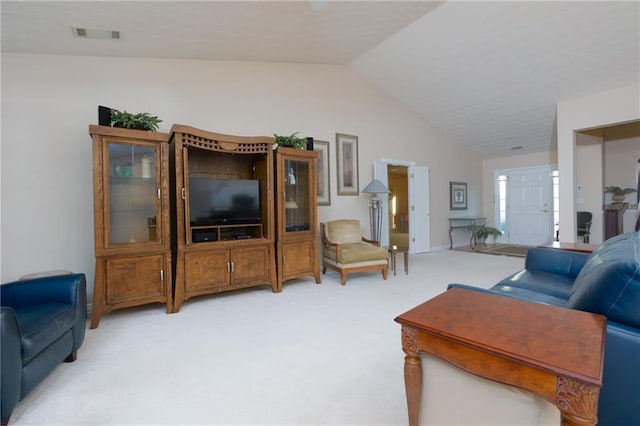 living room featuring light carpet, visible vents, and lofted ceiling