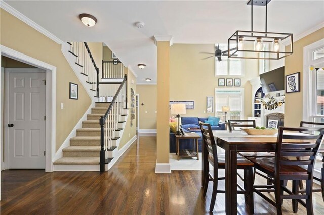 6317 Benbrooke Overlook NW, Acworth, GA 30101 - dining area featuring ceiling fan, wood finished floors, stairs, ornamental molding, and ornate columns