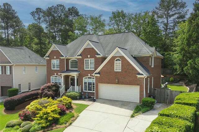 6317 Benbrooke Overlook NW, Acworth, GA 30101 - georgian-style home featuring an attached garage, brick siding, and driveway