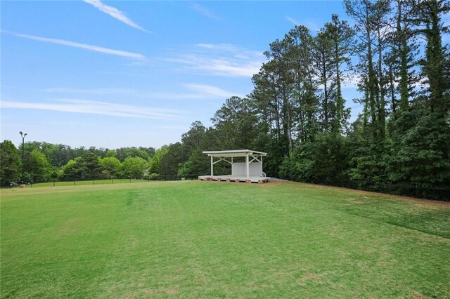 6317 Benbrooke Overlook NW, Acworth, GA 30101 - view of green lawn featuring a carport and a view of trees
