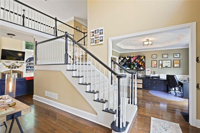 6317 Benbrooke Overlook NW, Acworth, GA 30101 - staircase with wood finished floors, ornamental molding, and a tray ceiling