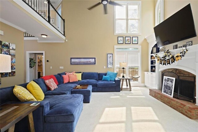 6317 Benbrooke Overlook NW, Acworth, GA 30101 - carpeted living area featuring a brick fireplace, a towering ceiling, ceiling fan, plenty of natural light, and ornamental molding