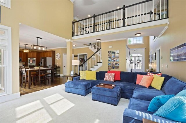 6317 Benbrooke Overlook NW, Acworth, GA 30101 - living room with a high ceiling, stairs, ornate columns, and wood finished floors