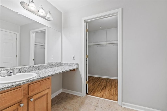 106 Brighton Pt, Sandy Springs, GA 30328 - bathroom featuring vanity, tile patterned floors, and a walk in closet