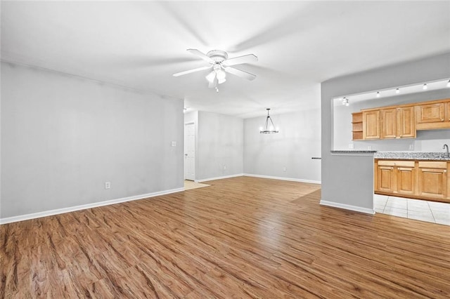 106 Brighton Pt, Sandy Springs, GA 30328 - unfurnished living room featuring light wood finished floors, ceiling fan, and a chandelier