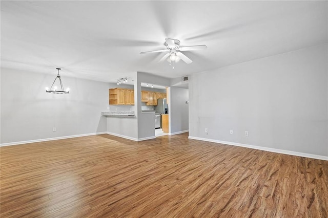 106 Brighton Pt, Sandy Springs, GA 30328 - unfurnished living room with wood finished floors, a chandelier, and ceiling fan