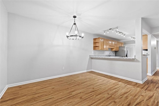 106 Brighton Pt, Sandy Springs, GA 30328 - kitchen featuring stainless steel refrigerator with ice dispenser, open shelves, wood finished floors, light countertops, and a chandelier