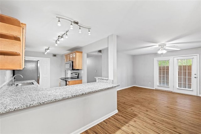 106 Brighton Pt, Sandy Springs, GA 30328 - kitchen with appliances with stainless steel finishes, a ceiling fan, open shelves, wood finished floors, and light stone countertops