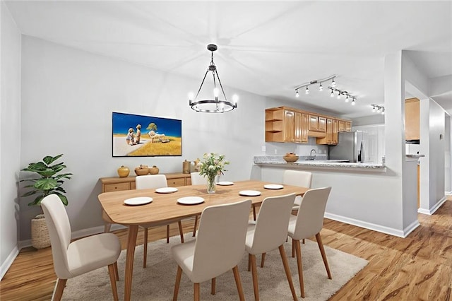 106 Brighton Pt, Sandy Springs, GA 30328 - dining space featuring light wood finished floors, a chandelier, and rail lighting