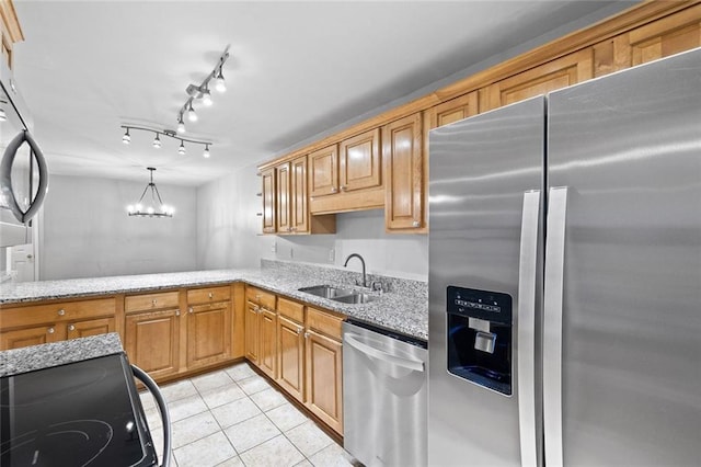 106 Brighton Pt, Sandy Springs, GA 30328 - kitchen with stainless steel appliances, light stone counters, light tile patterned floors, a chandelier, and decorative light fixtures