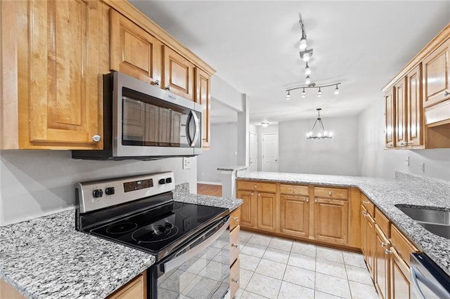 106 Brighton Pt, Sandy Springs, GA 30328 - kitchen with stainless steel appliances, a chandelier, light tile patterned floors, and light stone counters