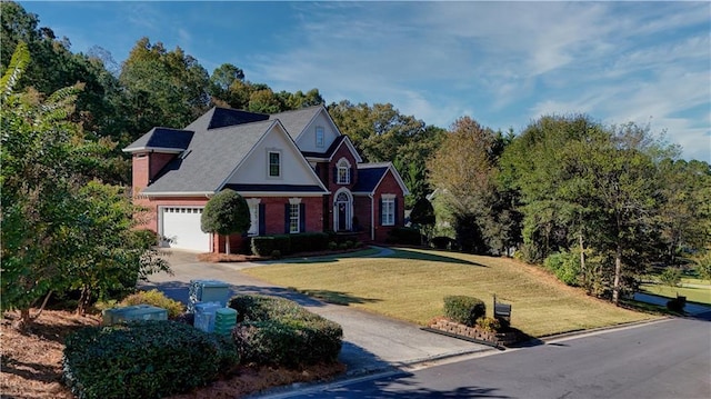 view of front of house featuring a garage, concrete driveway, and a front yard