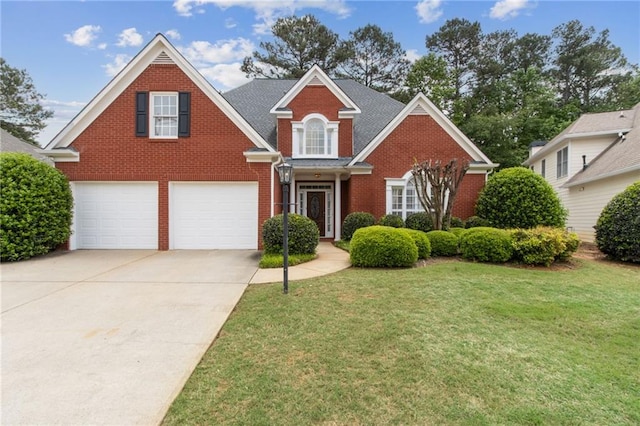 traditional-style home with brick siding, a front lawn, an attached garage, and concrete driveway