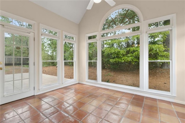 unfurnished sunroom with tile patterned floors and vaulted ceiling