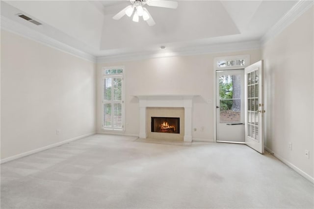 unfurnished living room with carpet flooring, visible vents, ornamental molding, and a fireplace