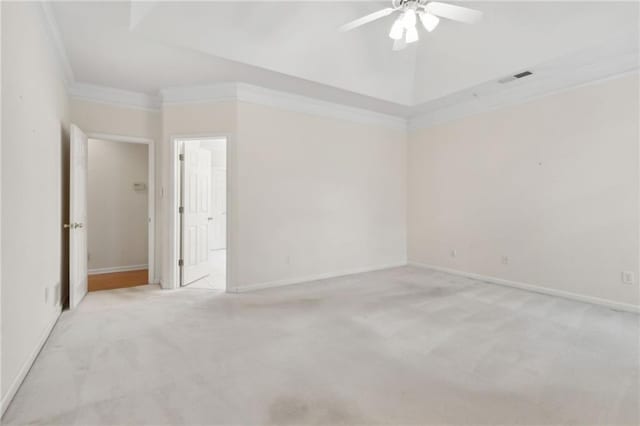 spare room featuring ceiling fan, light carpet, baseboards, visible vents, and ornamental molding
