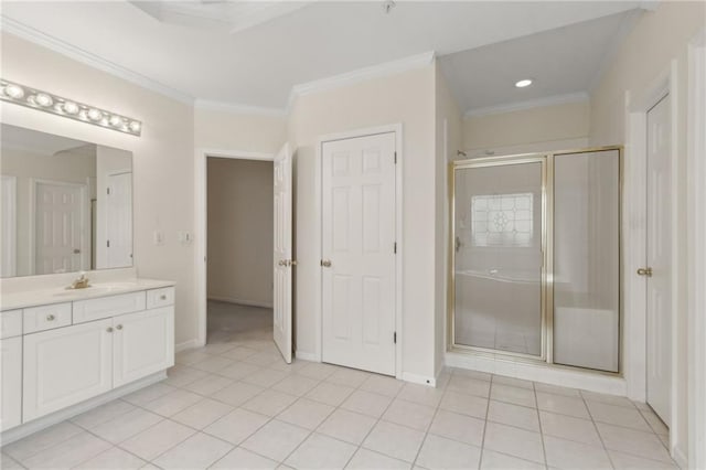 bathroom featuring tile patterned flooring, ornamental molding, vanity, baseboards, and a stall shower