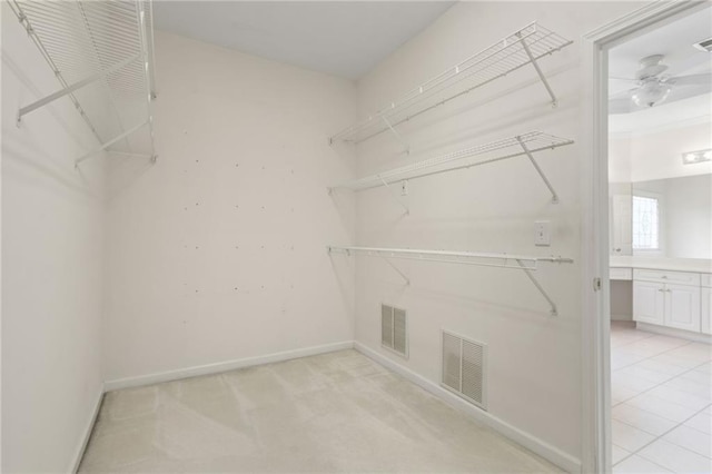 spacious closet with ceiling fan and visible vents