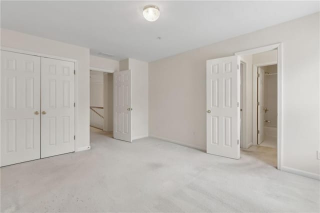 unfurnished bedroom featuring a closet, baseboards, and carpet flooring