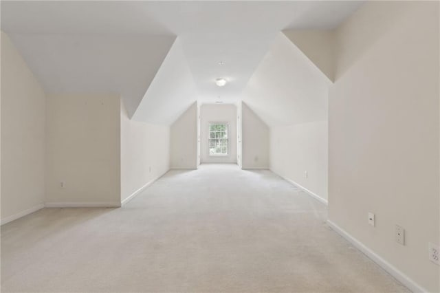 bonus room featuring carpet floors, baseboards, and vaulted ceiling