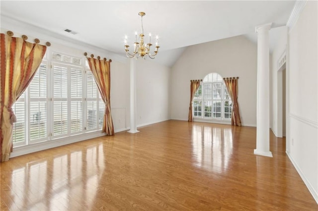interior space with a notable chandelier, ornate columns, wood finished floors, and visible vents