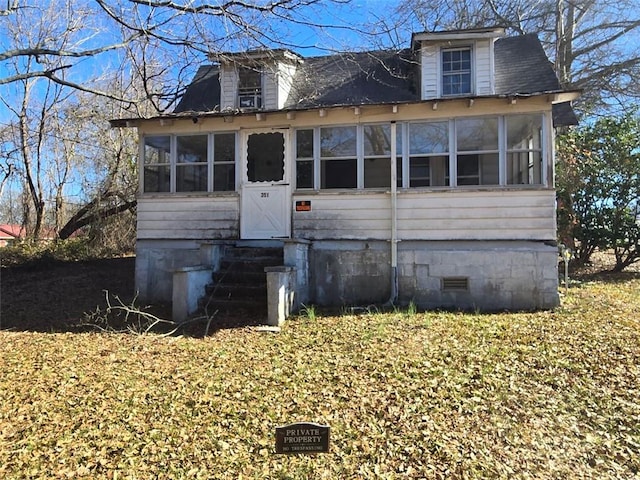 view of front of property featuring a sunroom