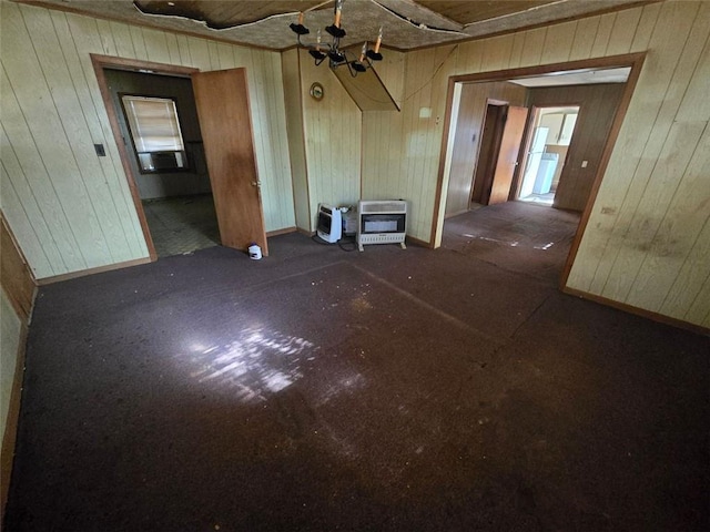 unfurnished living room with heating unit and a notable chandelier