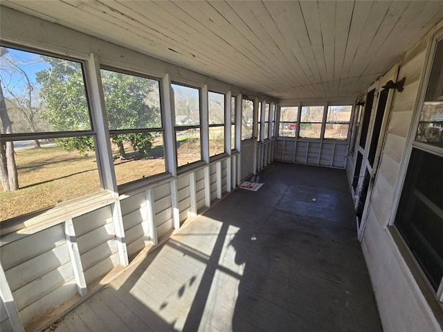 unfurnished sunroom with wood ceiling