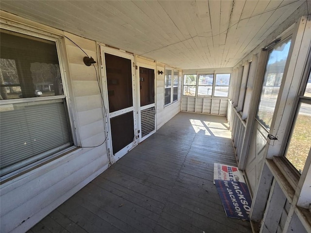 unfurnished sunroom with wooden ceiling