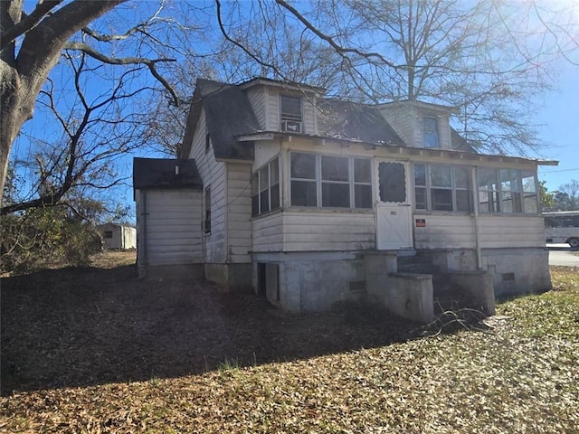 view of front of property featuring a sunroom