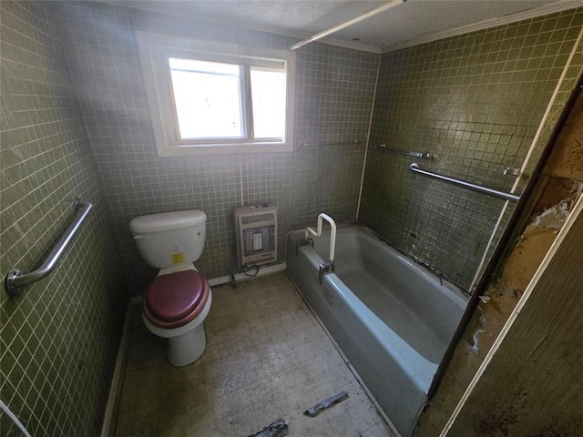 bathroom featuring ornamental molding, heating unit, shower / bathing tub combination, tile walls, and toilet