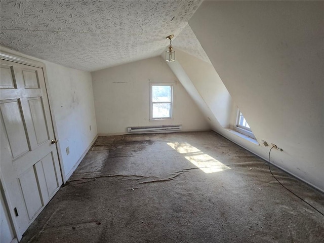 bonus room with baseboard heating, a textured ceiling, and vaulted ceiling