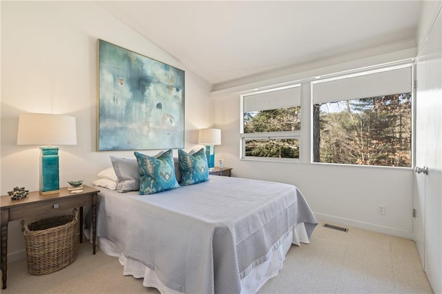 bedroom featuring visible vents, vaulted ceiling, baseboards, and multiple windows