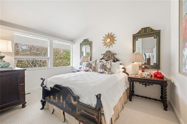 bedroom with light carpet, baseboards, and lofted ceiling