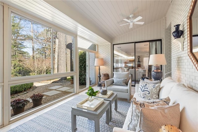 sunroom with a ceiling fan, lofted ceiling, and wooden ceiling