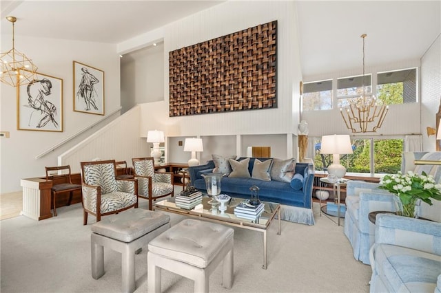 carpeted living room with a high ceiling, stairway, and an inviting chandelier