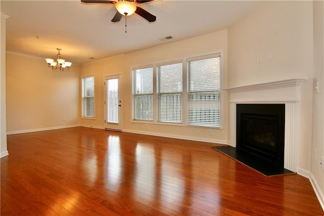 unfurnished living room featuring visible vents, baseboards, a glass covered fireplace, and hardwood / wood-style floors