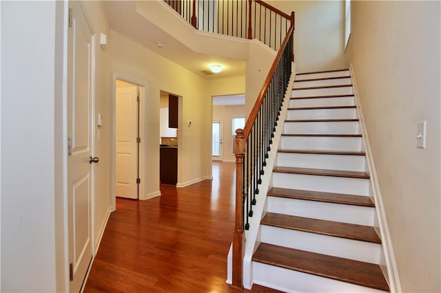 stairway with hardwood / wood-style flooring