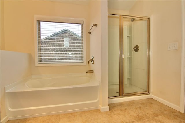 full bath with a bath, tile patterned flooring, a stall shower, and baseboards