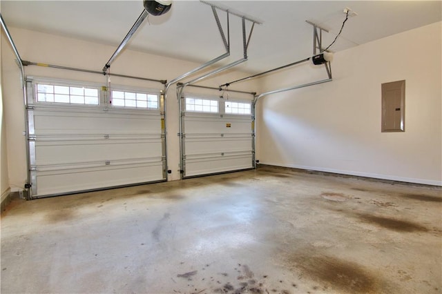 garage with electric panel, baseboards, and a garage door opener