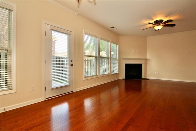 unfurnished living room featuring a fireplace with flush hearth, a ceiling fan, baseboards, and hardwood / wood-style floors