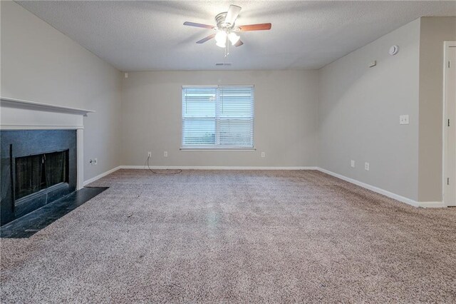 unfurnished living room featuring carpet flooring, ceiling fan, and a textured ceiling