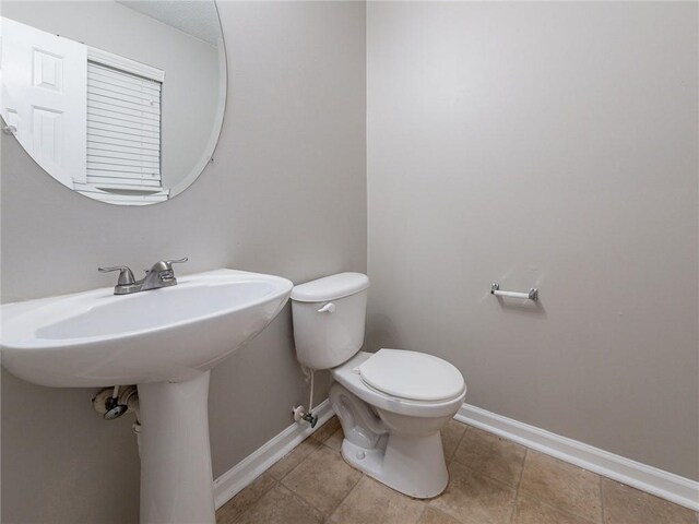 bathroom with tile patterned floors and toilet