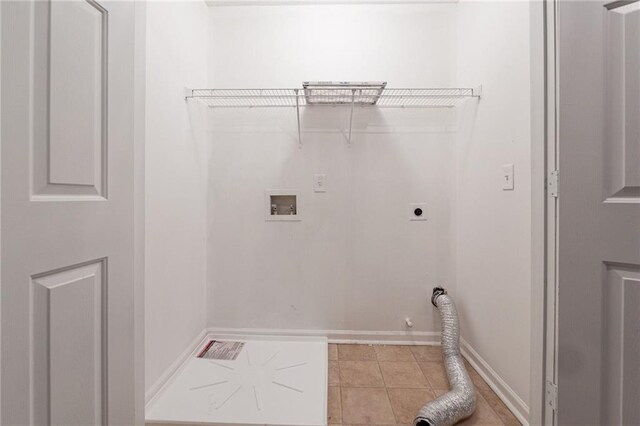 washroom featuring hookup for an electric dryer, gas dryer hookup, light tile patterned floors, and hookup for a washing machine