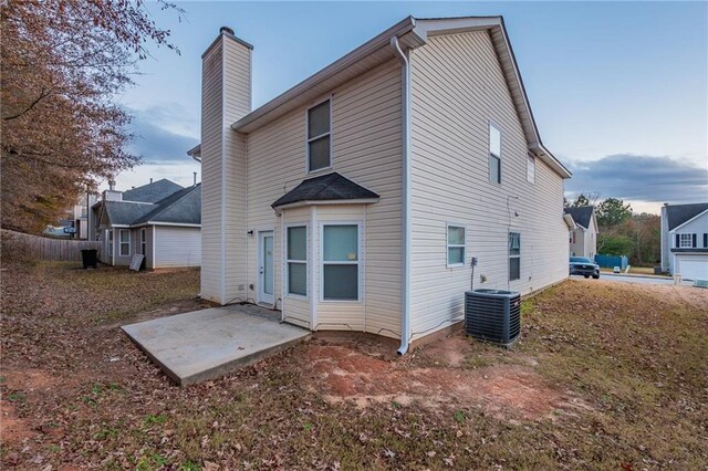 rear view of house with a patio area and central AC