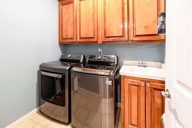109 Lighthorse Blvd, Mcdonough, GA 30252 - laundry room featuring cabinet space, washing machine and clothes dryer, light tile patterned flooring, and baseboards