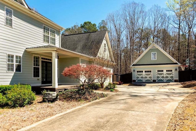 109 Lighthorse Blvd, Mcdonough, GA 30252 - view of side of home with a detached garage, an outbuilding, french doors, and a porch