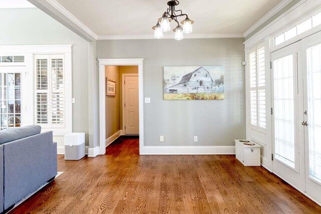 109 Lighthorse Blvd, Mcdonough, GA 30252 - entrance foyer featuring a chandelier, wood finished floors, crown molding, and baseboards