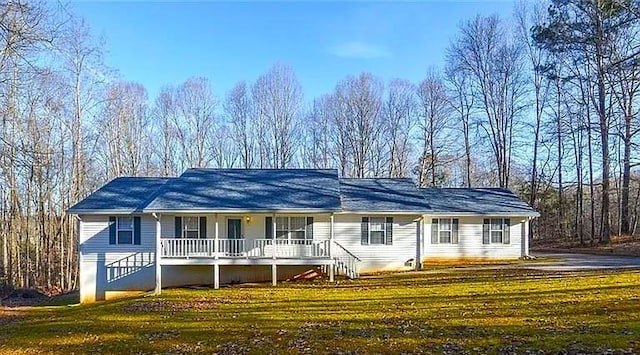 ranch-style home featuring a front yard and covered porch